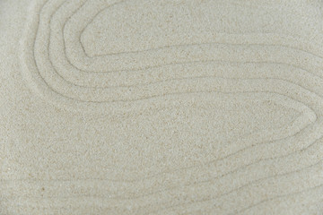 Abstract Zen drawing on white sand. Concept of harmony, balance and meditation, spa, massage, relax. Zen garden