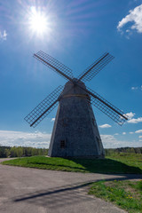 Fototapeta na wymiar Historic windmill in a lush green field