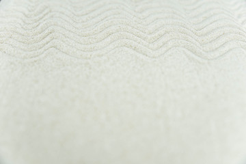 Abstract Zen drawing on white sand. Concept of harmony, balance and meditation, spa, massage, relax. Zen garden.