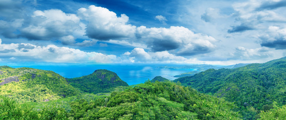 Panoramic aerial view of Mountains, Seascape and Vegetation at sunset