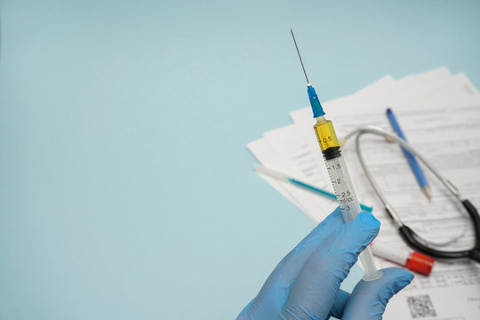 Doctor, Nurse, Scientist Hand In Blue Gloves Holding Covid-19 Vaccine Disease Preparing For Child, Baby, Adult, Man And Woman Vaccination Shot, Medicine And Drug Concept.