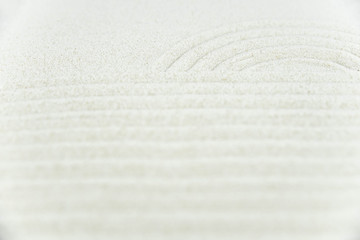 Abstract Zen drawing on white sand. Concept of harmony, balance and meditation, spa, massage, relax. Zen garden.