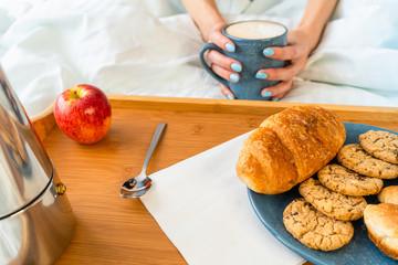 Obraz na płótnie Canvas Happy attractive woman wake up in the morning in bed. Good morning and fresh and beautiful breakfast on tray for the girl
