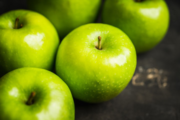 Close-up green apples on the rustic wooden background