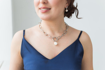 Close-up portrait of beautiful young woman with elegant hairstyle and luxurious jewelry and bijouterie.