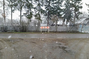 Road in village at winter snowy time