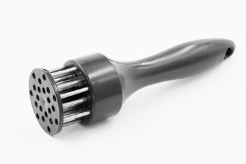 A hand-powered meat tenderizer for puncture the meat and cut into the fibers of the muscle on white background
