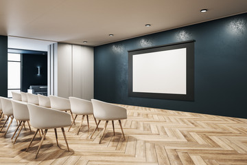 Contemporary presentation room with blank screen.
