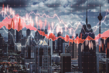 Stock charts hologram on modern skyscraper background.