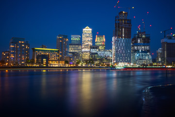 Fototapeta na wymiar Long exposure, Canary Wharf with new development in London at night