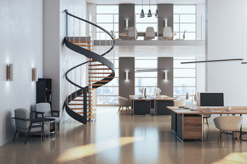 Contemporary coworking office interior with stairs and computer on desktop