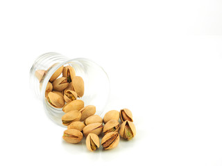 Pistachios in a glass isolated on a white background. High Vitamin B6 and antioxidants. Low in calories yet high in protein..