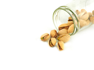 Pistachios in a bottle isolated on a white background. High Vitamin B6 and antioxidants. Low in calories yet high in protein.