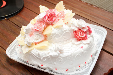 Obraz na płótnie Canvas Wedding cake with decoration and cream on the table