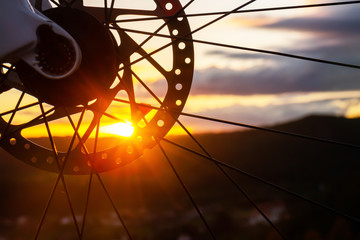 Bicycle wheel with sunset background