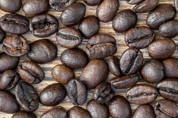 Close-up of coffee beans on dark wooden background. Top view