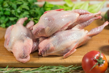 Plucked quail on a market table.