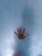 hand behind glass