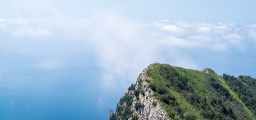 Hiker explores beautiful Capri Island, Italy on a hot summer day