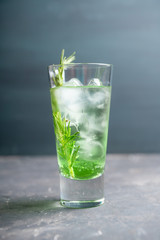 Sweet tequila based green cocktail with tarragon and rosemary. Selective focus. Shallow depth of field.