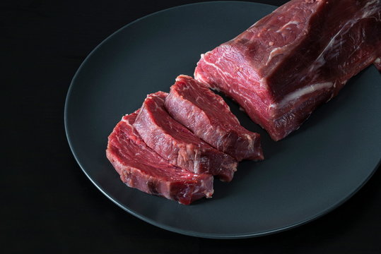 Chopped beef tenderloin, black background.