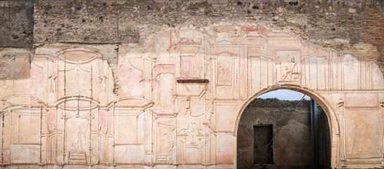 Hand sculpted walls at the Roman baths in the ruins of Pompeii, Italy.