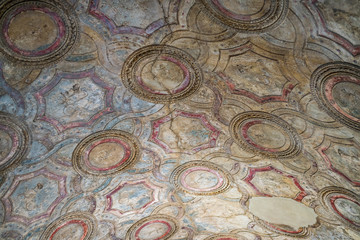 Hand sculpted and painted ceiling at the Roman baths in the ruins of Pompeii, Italy.