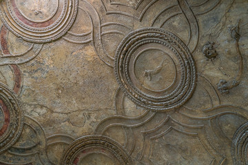 Hand sculpted and painted ceiling at the Roman baths in the ruins of Pompeii, Italy.