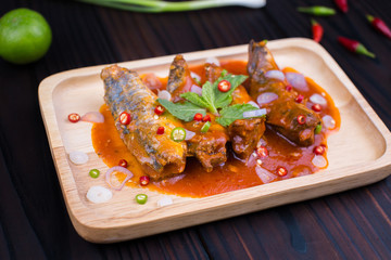 Spicy Canned Sardine Salad  with herb snd raw material on wooden plate.