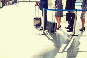 Portrait of business couple queuing for check in at airport