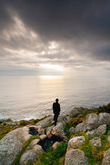 Fototapeta na wymiar Woman observing the horizon on a cliff
