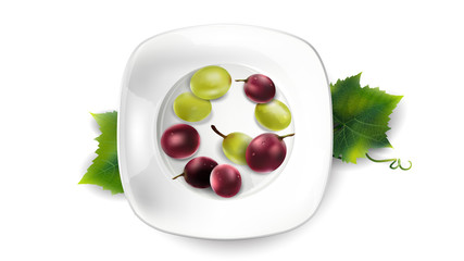 Green and red grapes on a white plate.