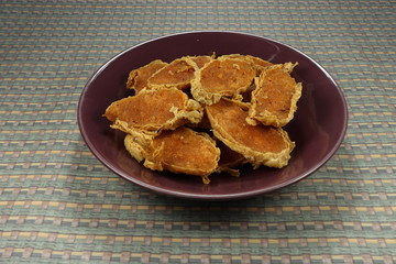 Pile of traditional deep fried crab and shrimp meat roll on the plate. Famous luxury crispy dim sum in Chinese restaurant. Ancient food in ceremony. 