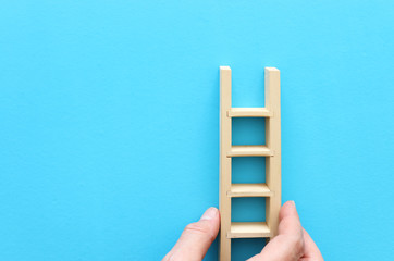 wooden ladder over blue background