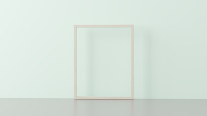 Wooden frame on empty pastel green wall.