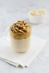 Macau coffee with milk and snacks on a light table.