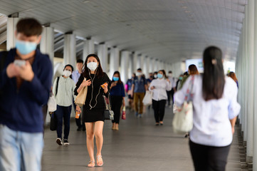 Crowd of asian people wearing face protection from infection of corona virus or Covid -19 outbreak