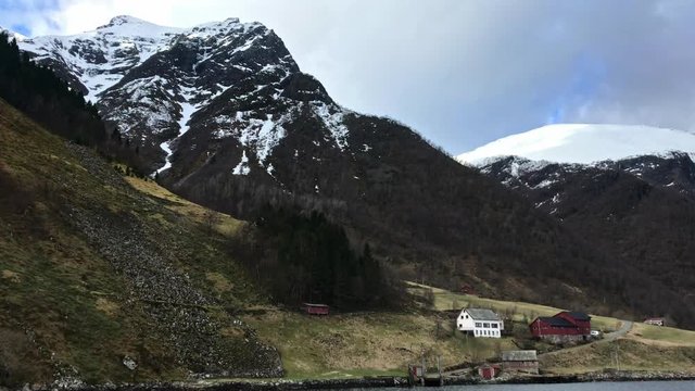 Ferry closing in to Sk&aring;r in &Oslash;rsta More og Romsdal Norway. Snow covered mountains and wild nature. Windy condition in the spring.