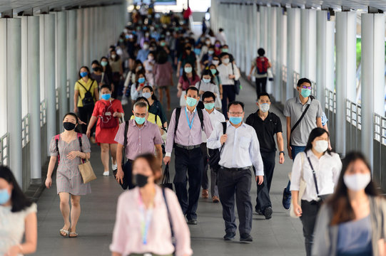 Crowd of people wearing surgical mask and walking at Bangkok downtown
