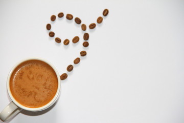 cup of coffee with beans on a white a background
place for text