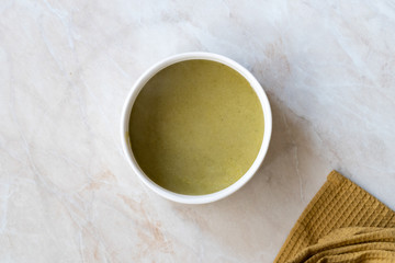 Homemade Healthy Organic Broccoli Soup with Grated Parmesan Cheese.
