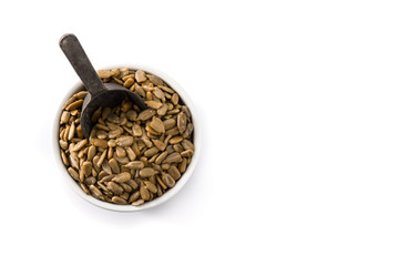 Sunflower seeds in bowl isolated on white background. Top view. Copy space