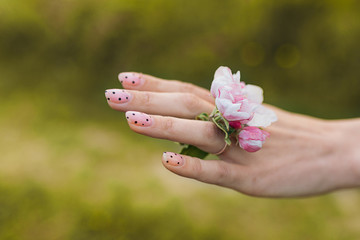 Girl showing a ring from a blooming apple tree on her hand. The concept of spring, joy, happiness, new life. Copy spase, background