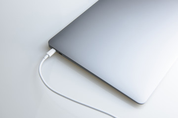 Close-up top view of laptop, in grey color on white isolated background
