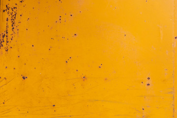 Yellow painted old rusty metal surface. An oxidized weathered surface with paint on it and a vintage texture and structure. Material effect