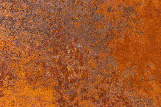 Orange textured old rusty metal surface. An weathered oxidized patina with a copper color, texture and structure. Vintage material effect