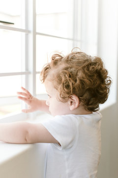 todler staring out of the window