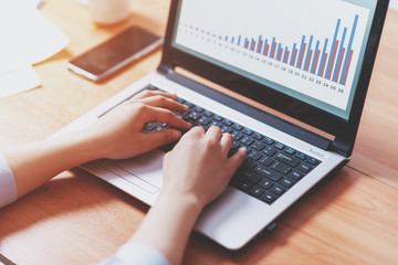 Woman working at home office hand on keyboard close up