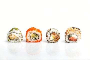 Four Japanese maki sushi rolls in a row with salmon, sesame, avocado, cheese isolated on white background. Side view