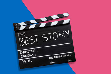 Naklejka premium The best story.Text title on movie clapperboard on pink and blue color background